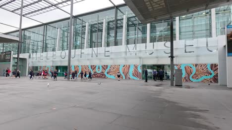 people walking outside melbourne museum entrance