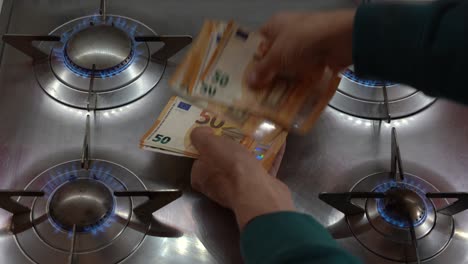 increase in the cost of raw materials due war conflict ukraine russia, energy and gas and in household bills - money euro cash banknotes and gas cookers