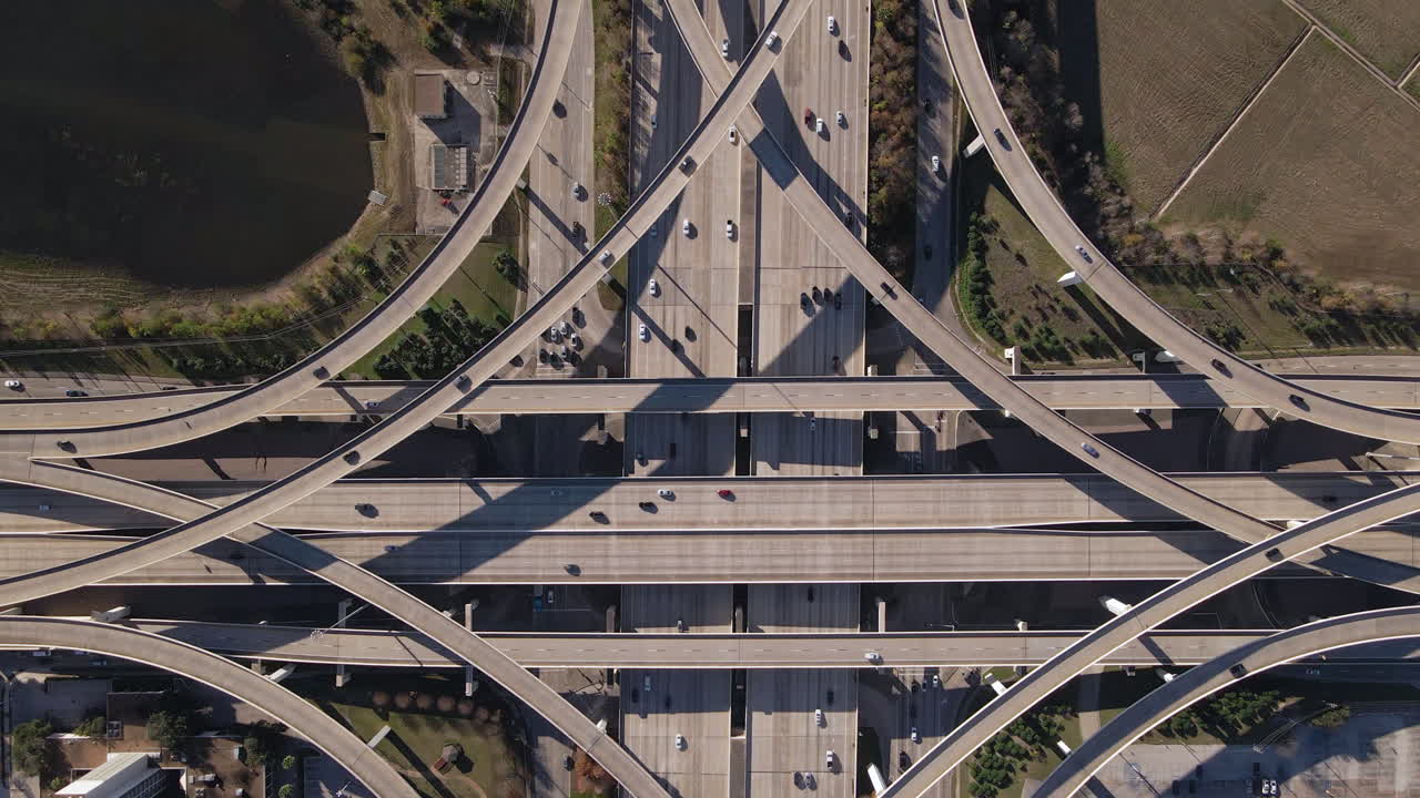 Bird Eye View of freeway I-10 and Sam Houston Tollway in  Houston Texas. Top Down Establishing shot of biggest freeway intersection in Texas. Busy multiple lanes freeway interchange in the U.S