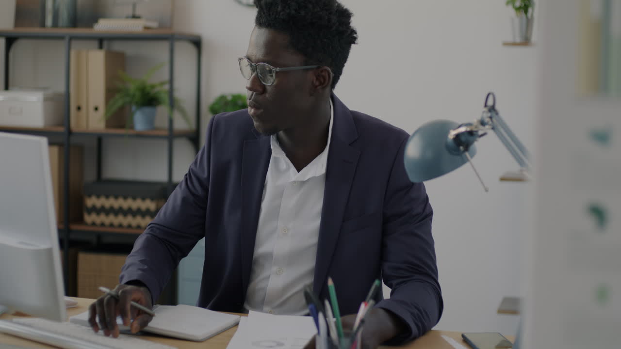 Man Working at a Computer in an Office