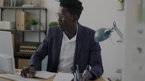 man working at a computer in an office