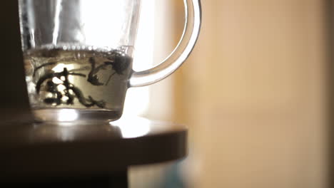 pouring a mug of herbal tea