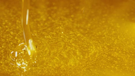 close-up of oil pouring and splashing