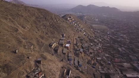 rustic hillside homes contrast with the dense urban landscape below. a striking aerial perspective on urbanization, poverty, and social inequality. ideal for documentary, editorial, and research use.