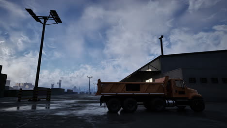 a dump truck parked outside a warehouse in a city