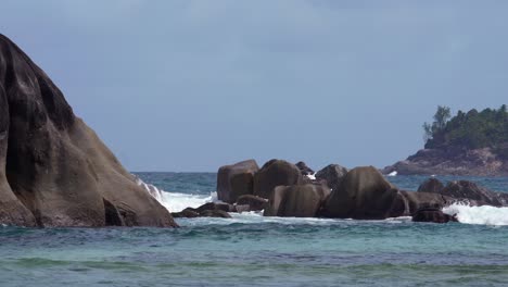 waves crushing on the granite stones near the reef of mahe island, seychelles 30fps 1