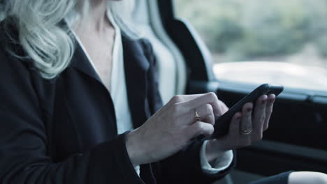 close up of mobile phone in businesswoman's hands