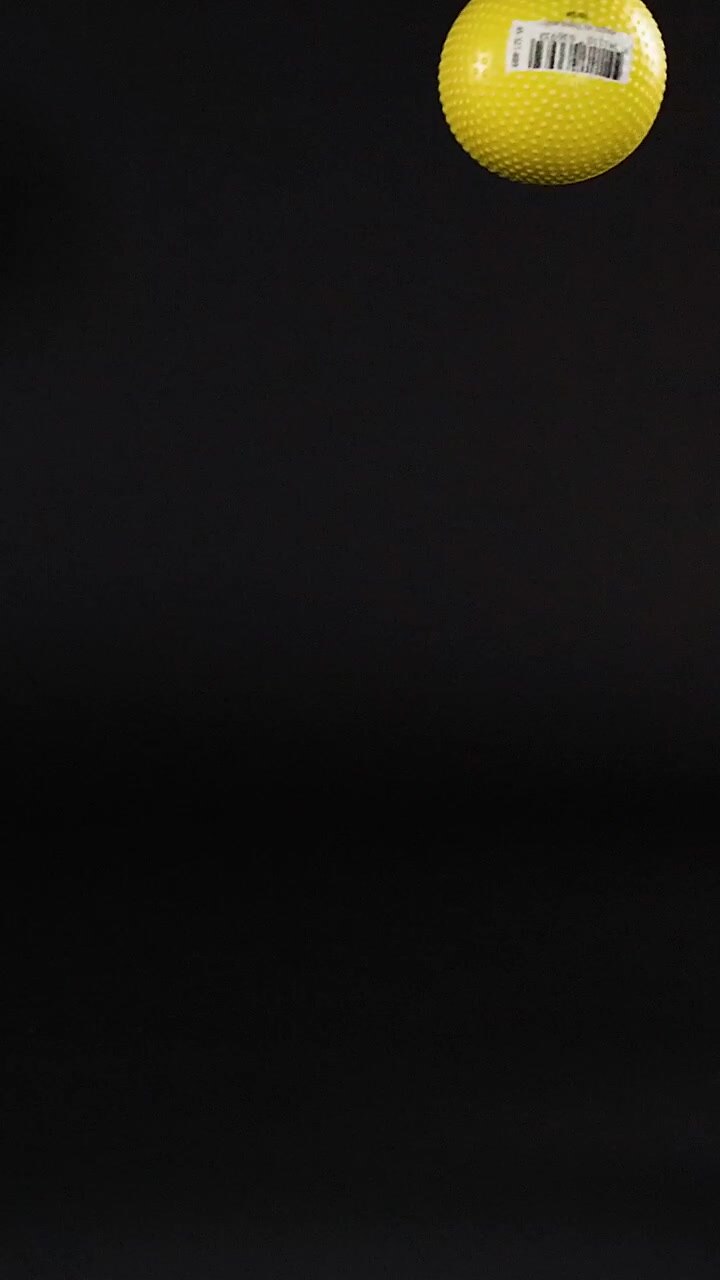 A yellow ball bounces against a dark background