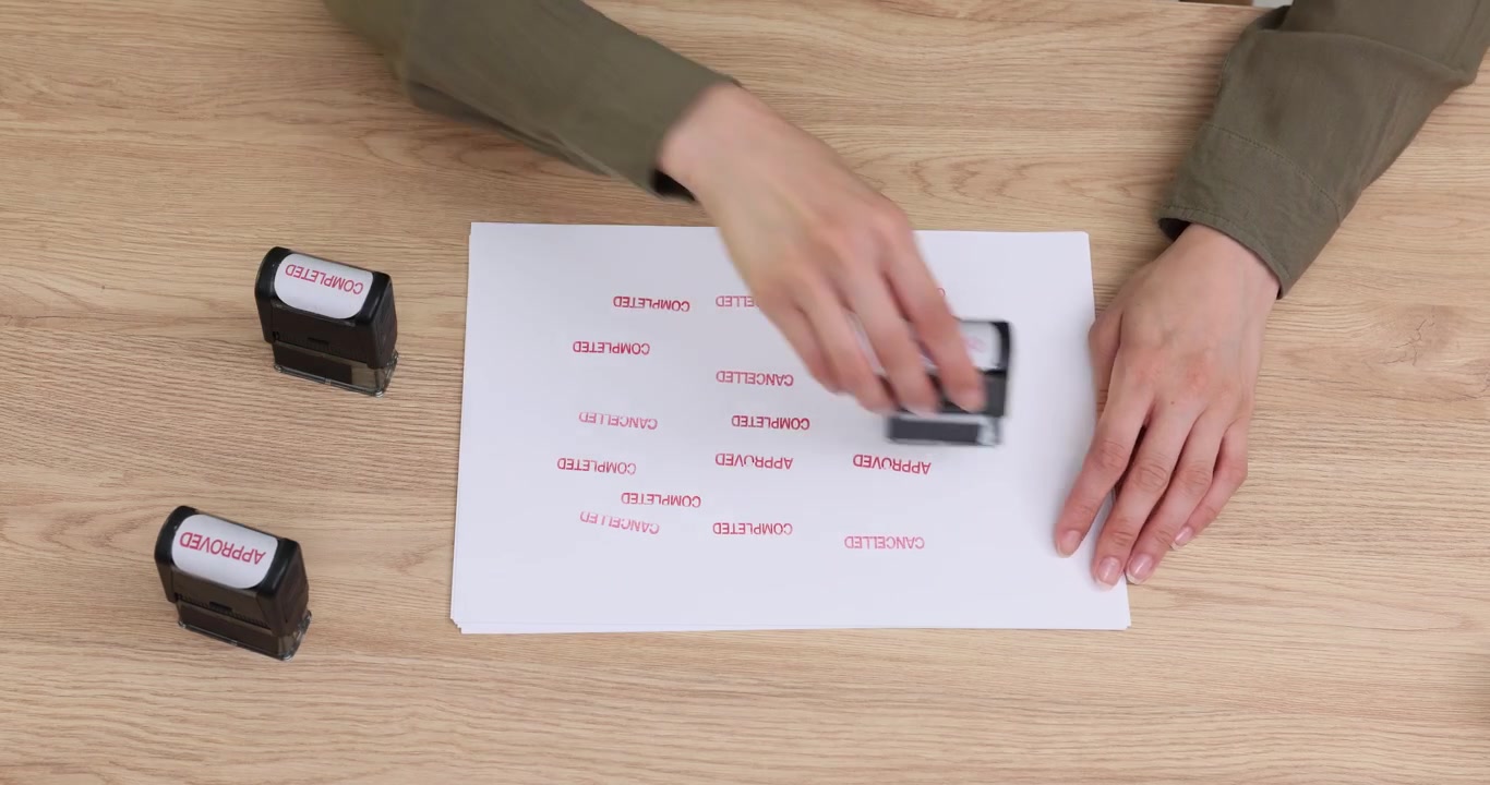 Woman office worker tests freshly refilled rubber stamp