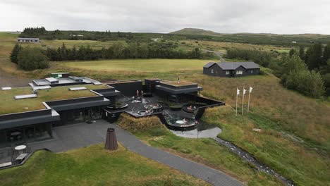 Experience tranquility from above with this 4K drone view of Krauma Baths, showcasing blissful visitors indulging in the geothermal spa pools&#039; embrace