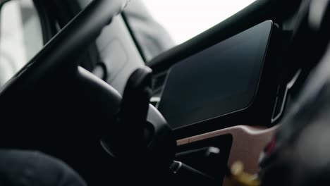 close up driver peeling plastic screen protector of a freightliner cascadia volvo 2023