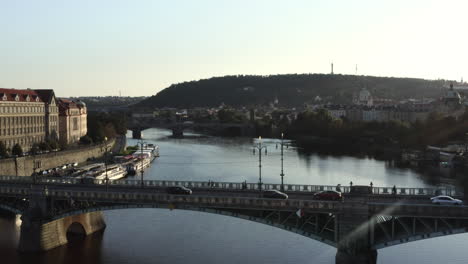 traffic on a bridge over vltava river, prague, czechia, city skyline