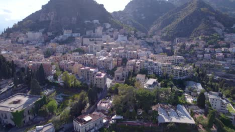 Aerial-orbit-over-the-north-side-of-Taormina,-Sicily,-Italy-a-famous-tourist-destination