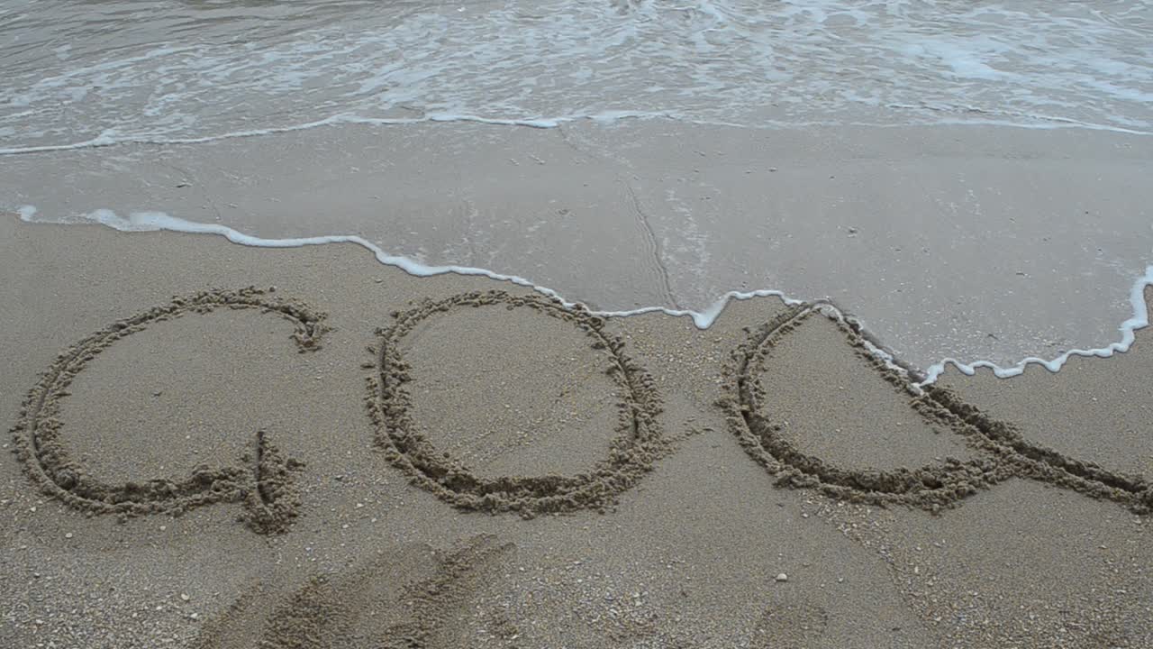 Goa title on the sand beach near the ocean. Shooting on the beach
