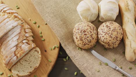 video of bread on chopping wooden board on wooden worktop