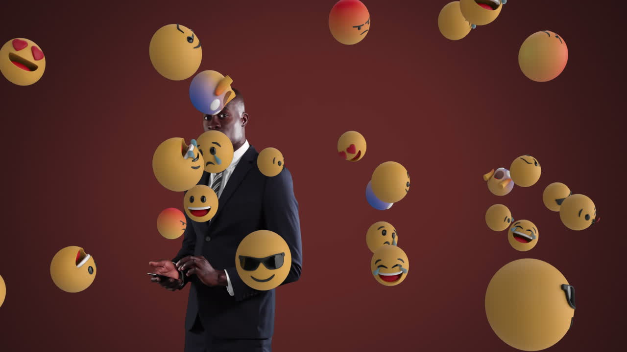 hombre de negocios afroamericano usando un teléfono inteligente con emoticones desovando