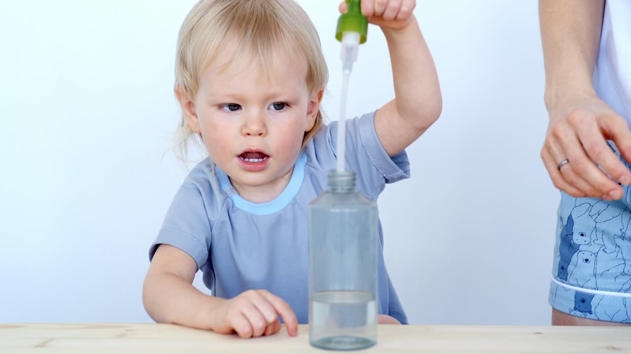 Toddler learning hand hygiene with mother