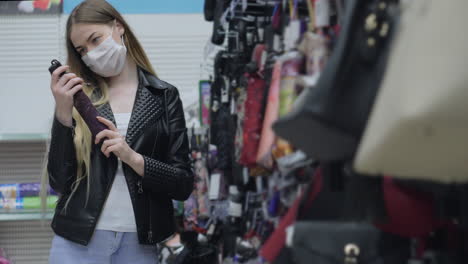 woman shopping for accessories in a store wearing a mask