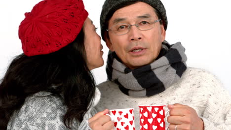 couple both having warm drinks