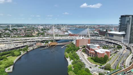 drone shot of the charles river passing under the zakim bridge in boston, ma