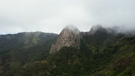 Rotating-Aerial-View-Over-La-Gomera's-Vast-Forest,-Obscured-by-Thick-Clouds,-Canary-Islands,-Spain