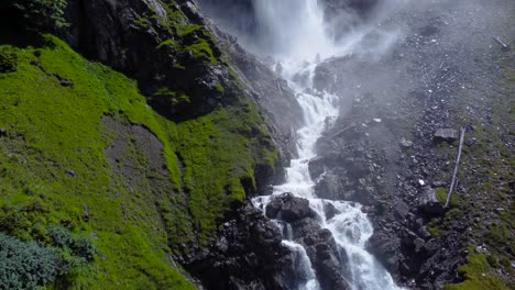 aerial rising along epic staubifall waterfall mist pours over basalt rocks