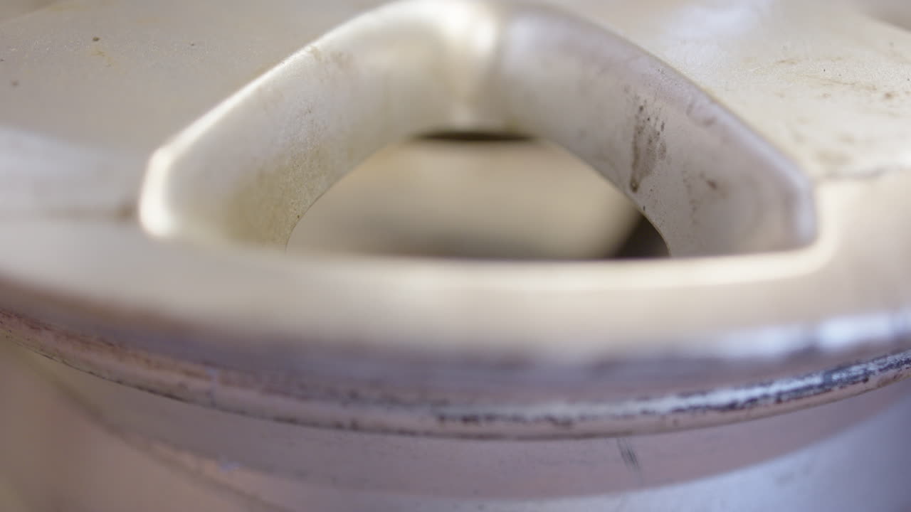 Pulling out faulty leaking valve from car rim, shallow focus close-up