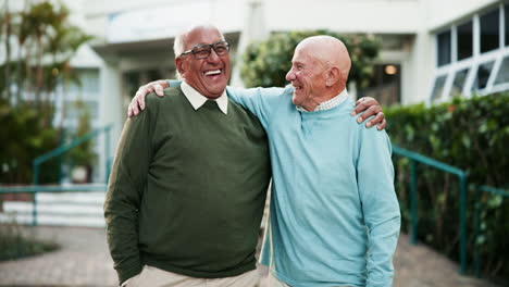 two senior men embracing outdoors