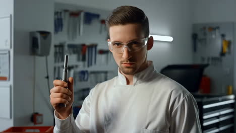 man holding tool in workshop