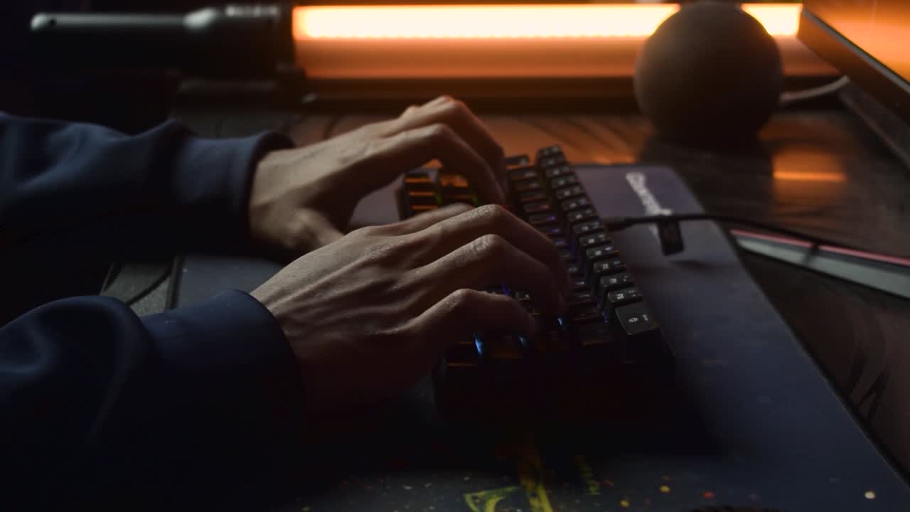 Typing on RGB gaming keyboard. desktop gaming computer