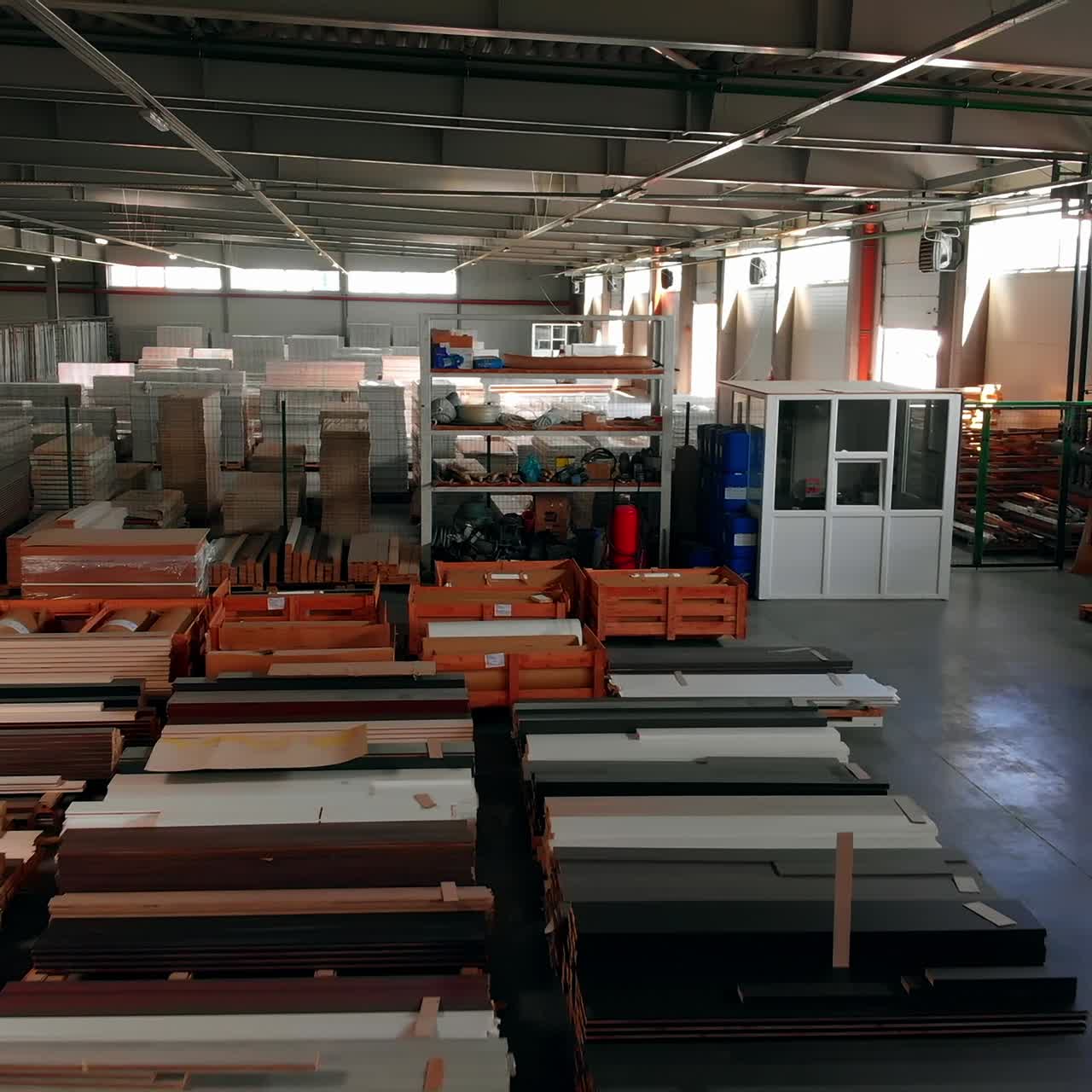 Storehouse with materials for door production of diverse colors. Huge warehouse backdrop