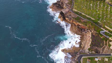 Bird's-Eye-View-Of-Coastal-Graveyard-Waverly-Cemetery-And-Blue-Waterscape-Of-Bronte-Beach-In-New-South-Wales,-Australia