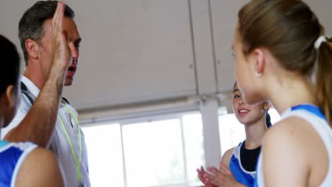 basketball coach giving high five to high school kids 4k