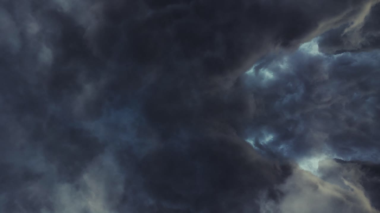 a thunderstorm inside the cumulonimbus clouds moving above the sky