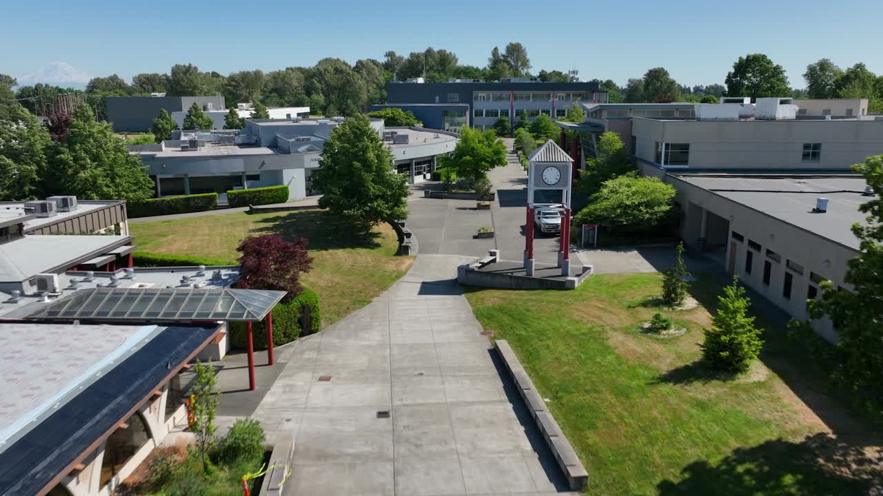 Aerial view flying through South Seattle College's empty campus on a warm summer day