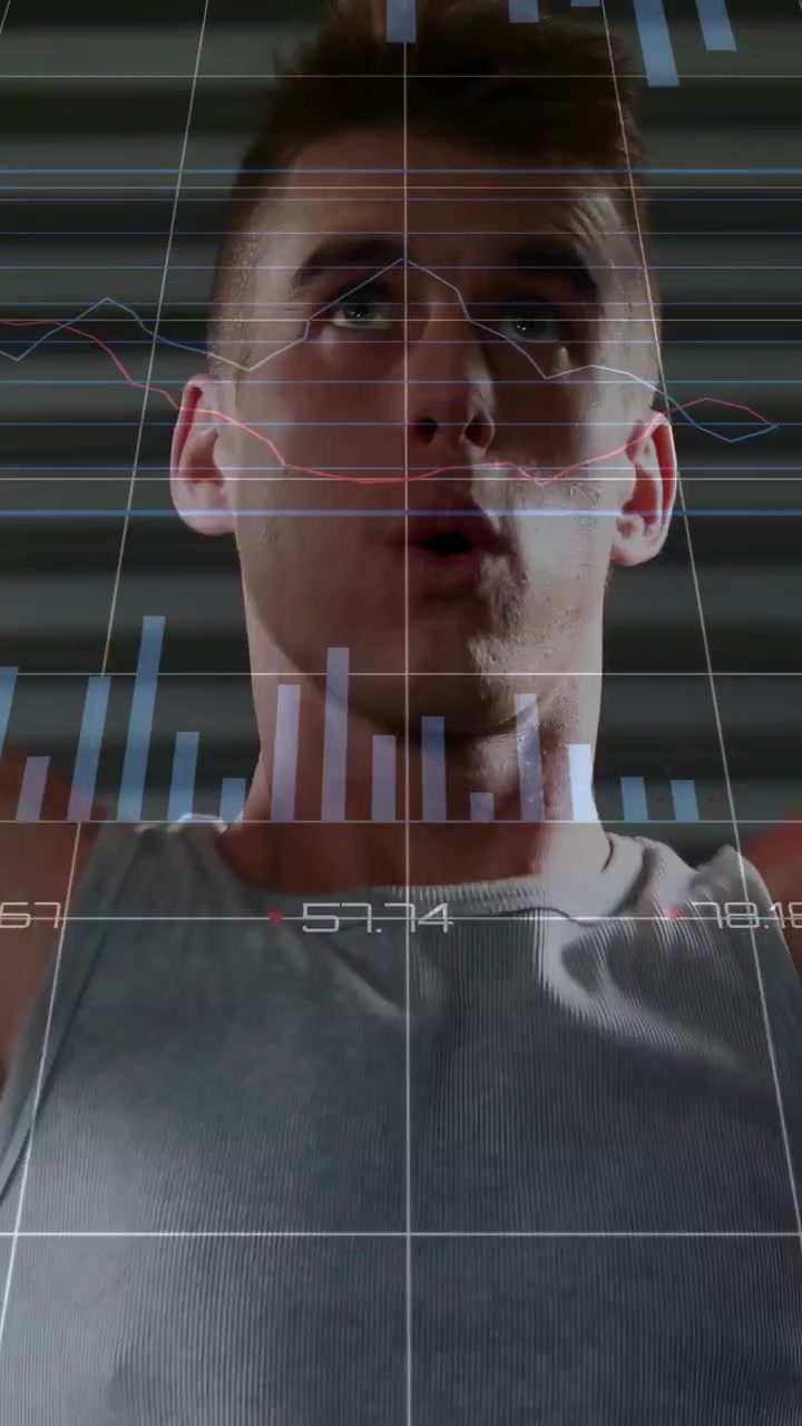 Vertical video: Man raising arms in gym, causing fitness bar charts updating on chest for metrics