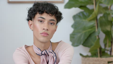 sitting at home, non binary person looking confidently at camera