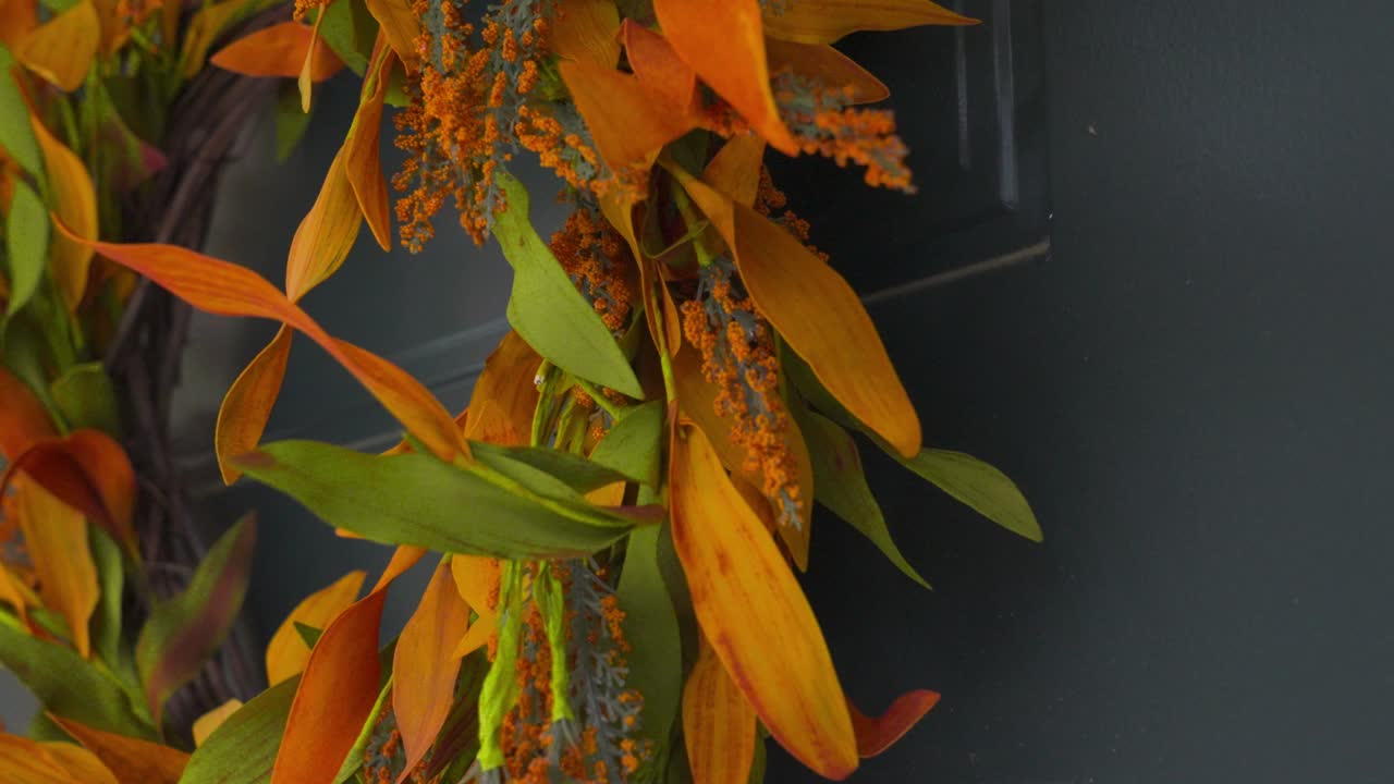 Pushing in to show the full wreath ornament on the door