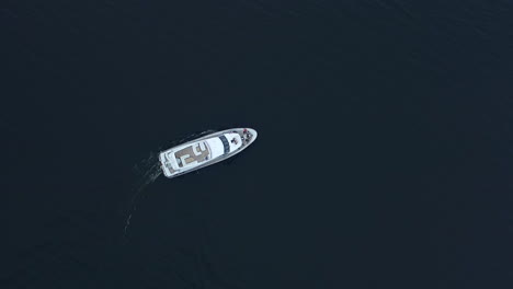 Luxury-yacht-sailing-deep-water.-Aerial-view-of-white-boat-turning-around