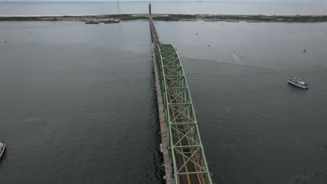 an aerial view of the fire island inlet bridge during a cloudy morning with calm waters