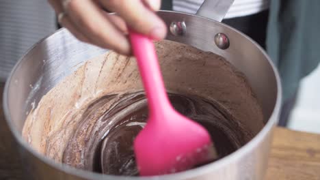 baker mixes chocolate ganache slow mo