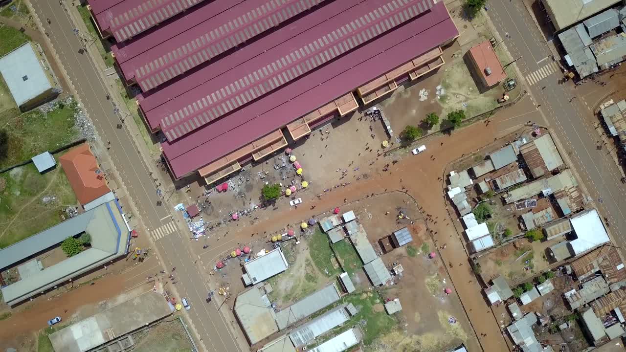 Aerial view showcases the bustling Central Market in Moroto Town, Karamoja, Uganda, capturing the vibrant energy of daily life and commerce in this East African trading hub, drone spin descending shot