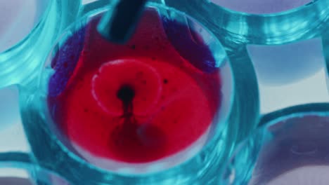 pouring blood into liquid with pipette during laboratory test