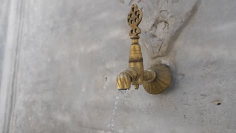 Water flowing from an antique faucet