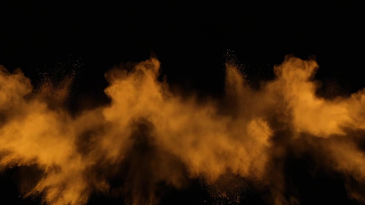 Esplosione di particelle di polvere dorata su sfondo nero