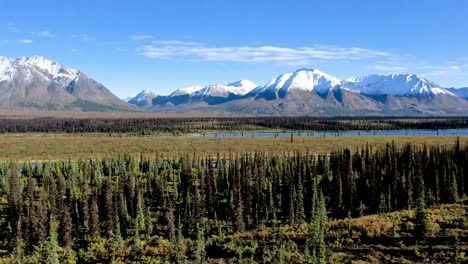 aerial view of cinematic alaska landscape rivers, snow capped mountains