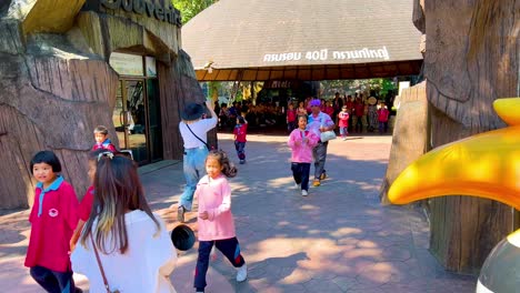 people entering zoo, enjoying a sunny day