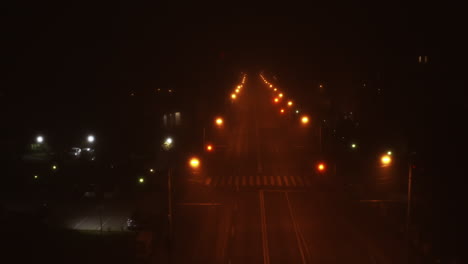 Spooky-road-and-street-lights-at-night-with-an-empty-road