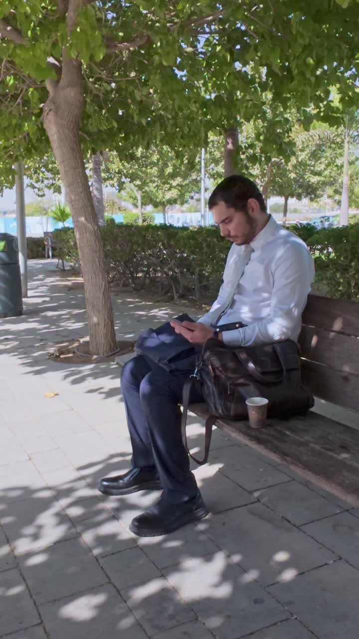 Businessman working on tablet in the park