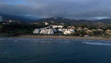 Aerial-drone-shot-of-residential-coastal-buildings-moving-forward